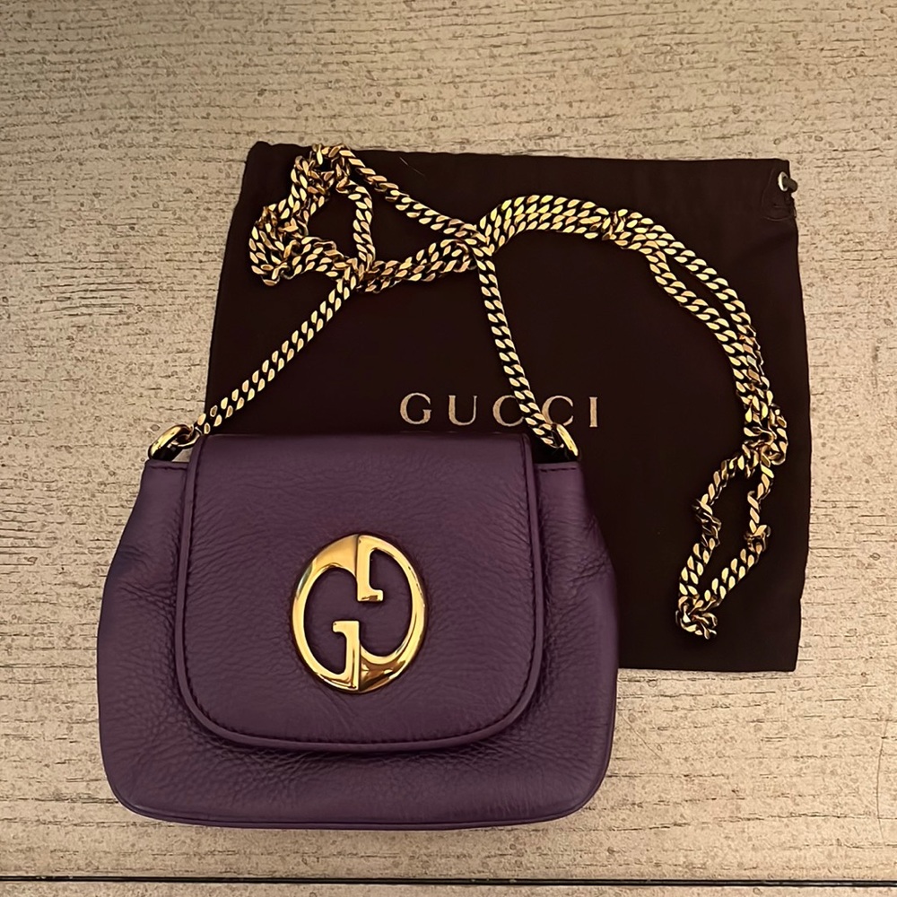 Gucci cross body vibrant purple bag with gold chain.
